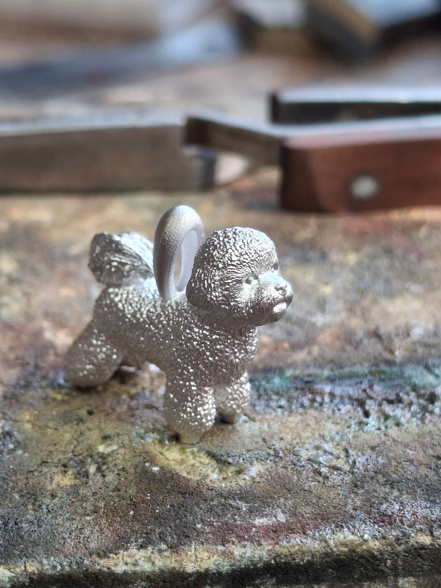 Silver dog pendant necklace with textured fur details on a chain, perfect accessory for dog lovers and jewellery enthusiasts worldwide, also available in solid gold. Made by Chris Simpson Designs in the United Kingdom.